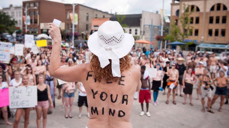 Diane Brisebois, coordinator for GoTopless.org, speaks at the Bare With Us Rally in Waterloo, Ont., on Saturday, Aug. 1, 2015. (Hannah Yoon/ THE CANADIAN PRESS)