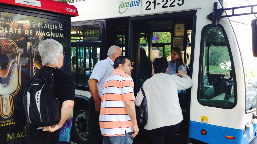 Commuters board buses at Lionel Groulx metro
