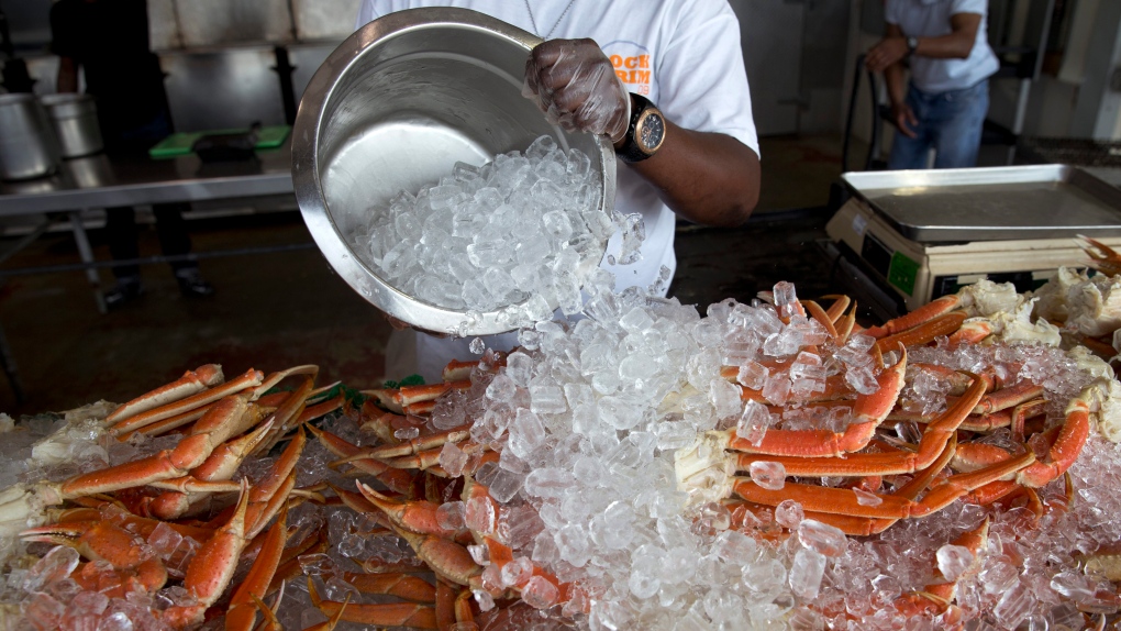 Man pours ice on seafood