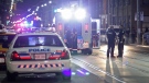 Paramedics and police stand at the scene of a shooting in downtown Toronto early Wednesday, Aug. 19, 2015. (John Hanley / CTV Toronto)