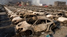 Smoke rises from the site of an explosion that reduced a parking lot of new cars to charred remains at a port warehouse in northeastern China's Tianjin municipality on Aug. 13, 2015. (AP / Ng Han Guan)