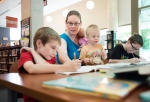 Lisa Marie Fletcher, second from left, helps her children with math lessons at the Whitby Central Library in Whitby, Ont. on Tuesday, Aug. 11, 2015. (THE CANADIAN PRESS / Darren Calabrese)