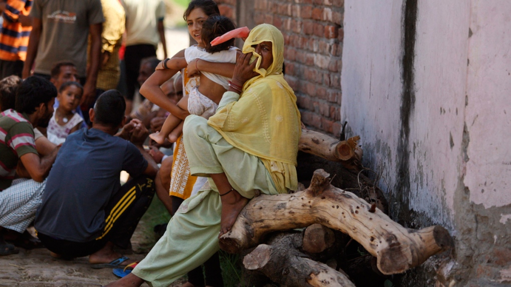 Indian villagers take shelter