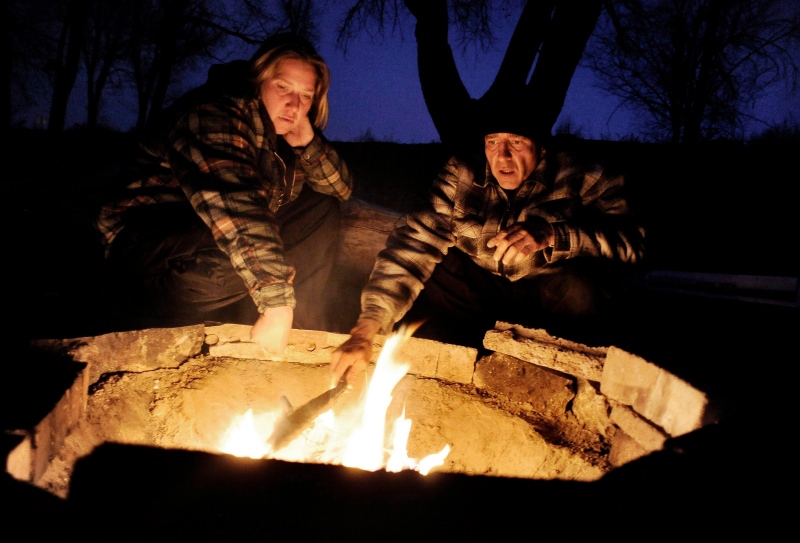 A couple warms themselves by a campfire in Colorado Springs, Colo. in this file photo from Jan. 21, 2010. ( The Denver Post/Craig F. Walker)