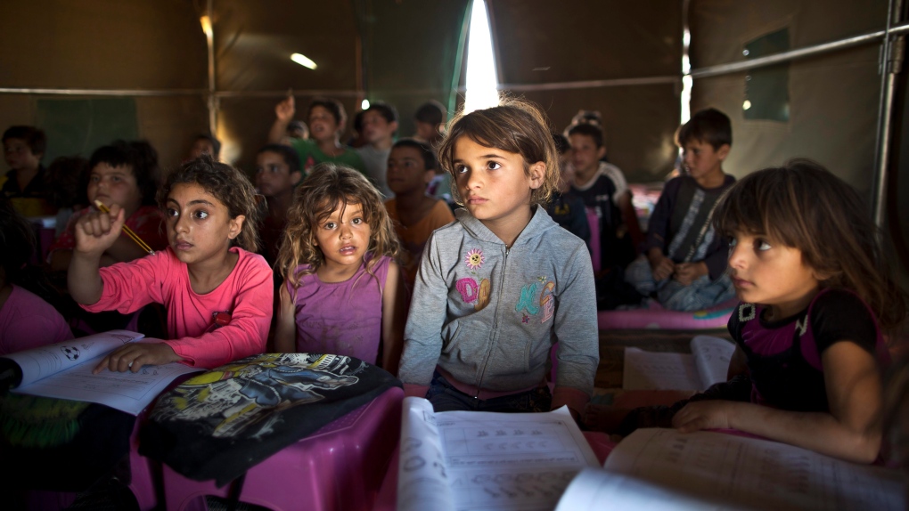 Syrian refugee children attend makeshift school