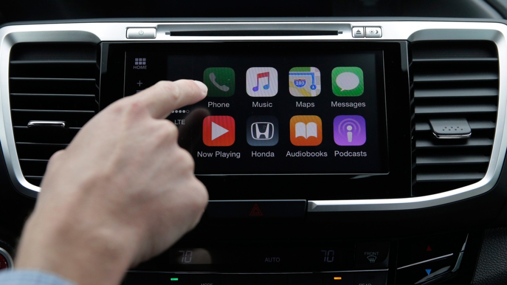 Demonstrating Apple CarPlay technology in a Honda