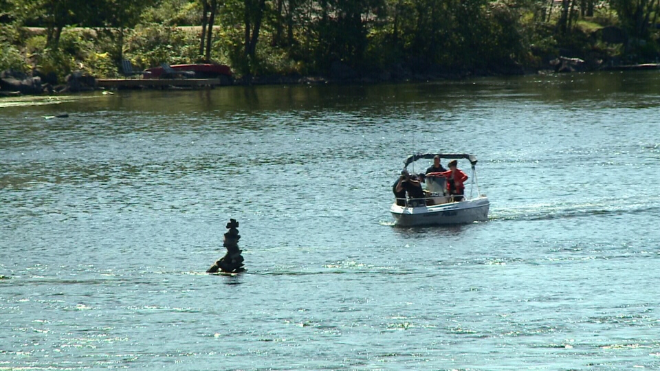 Police in patrol boats search for body.