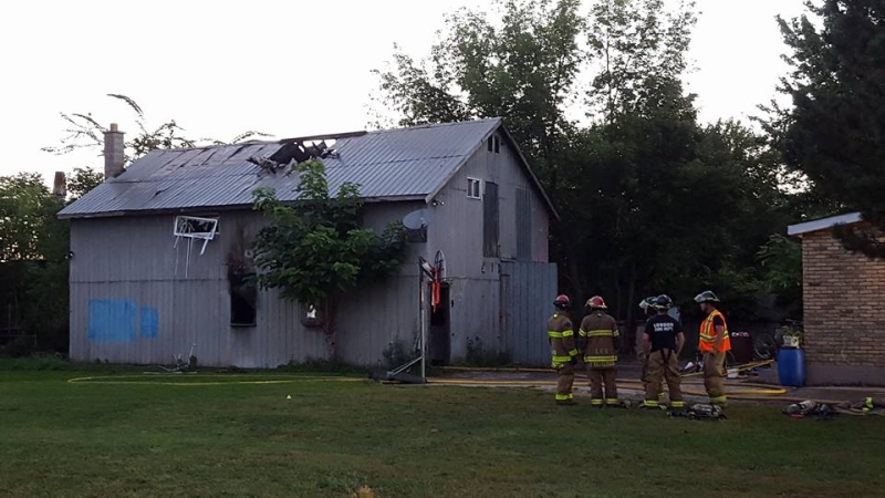 Fire crews assess the damage to a garage-apartment on Simcoe Street in London, Ont, on Monday, September 14, 2015. (CTV London / Justin Zadorsky) 