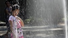 In this Aug. 17, 2015 file photo, a child plays in the sprinklers of Seward park in New York. The National Oceanic and Atmospheric Administration announced Thursday that last month, this past summer and the first eight months of 2015 all smashed global records for heat. (AP Photo/Mary Altaffer, File)