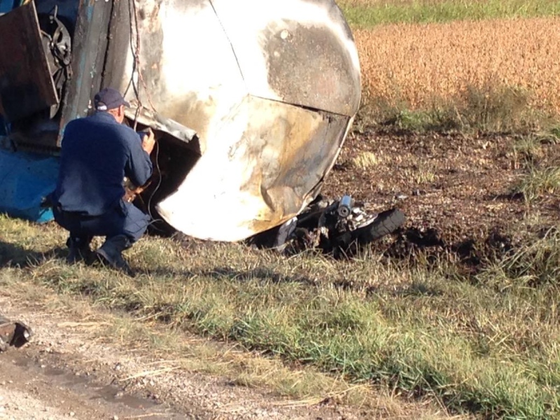 A motorcycle can be seen under an overturned tanker after a three-vehicle crash east of Courtright, Ont. on Tuesday, Sept. 22, 2015. (Jim Knight / CTV London)