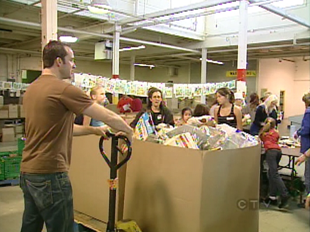 Volunteers sort food at the Daily Bread food bank in Toronto, Saturday, Oct. 11, 2008.