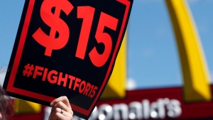 In this July 22, 2015 file photo, supporters of a $15 minimum wage for fast food workers rally in front of a McDonald's in Albany, N.Y.  (AP Photo/Mike Groll)