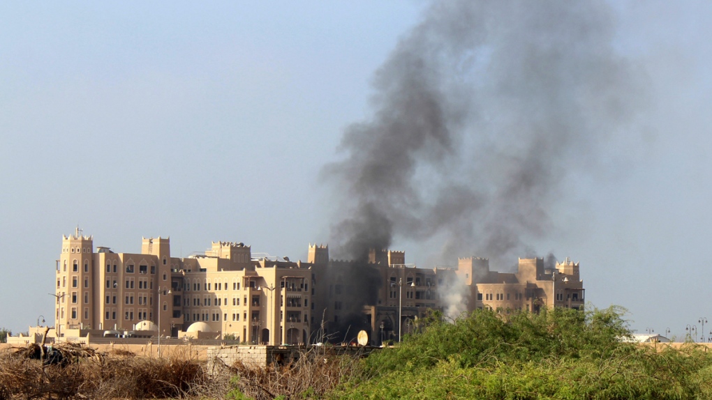 Smoke rises from Hotel al-Qasr in Aden, Yemen
