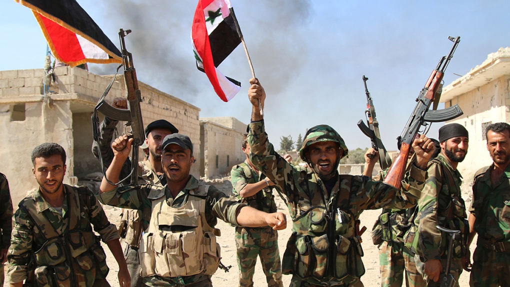 Syrian soldiers waving Syrian flags