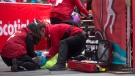A man receives medical attention after collapsing at the finish line of the half marathon during the Scotiabank Toronto Waterfront Marathon in Toronto, Sunday, Oct, 18, 2015. (Marta Iwanek / THE CANADIAN PRESS)