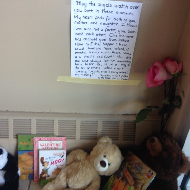 A touching note is posted above a tribute inside an apartment building for a six-year-old who was stabbed in London, Ont., Friday, Oct. 23, 2015. 
