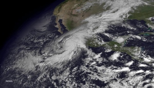 This satellite image taken at 10:45 a.m. EDT on Friday, Oct. 23, 2015, and released by the National Oceanic and Atmospheric Administration shows Hurricane Patricia moving over Mexico's Pacific Coast. (NOAA via AP)