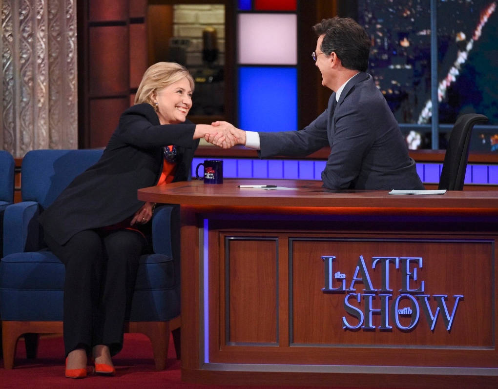 Hillary Clinton shakes hands with Stephen Colbert