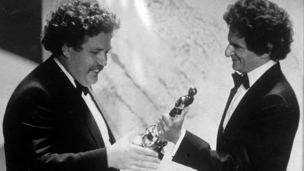 Colin Welland, left, accepts an Oscar 