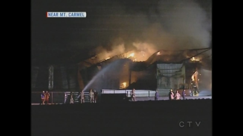 Fire crews battle a barn blaze near Mt. Carmel, Ont. on Tuesday, Nov. 3, 2015. 