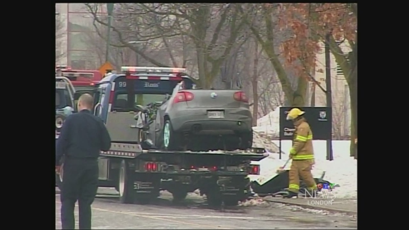 What remains of a vehicle involved in a fatal crash on Perth Drive in London, Ont. is removed from the scene on Sunday, Jan.18, 2015. 