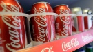 Cans of Coca-Cola sit in a refrigerator in San Francisco, on June 30, 2014. (AP Photo/Jeff Chiu)