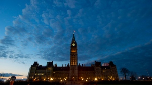 The sun sets behind Parliament Hill in Ottawa on Thursday, November 5, 2015. (Sean Kilpatrick / THE CANADIAN PRESS)