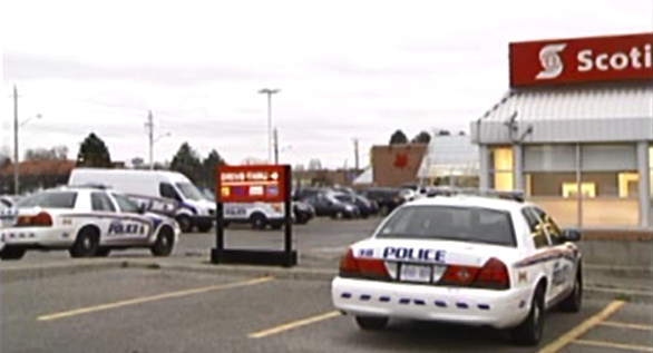 Police cruisers park outside the Scotia Bank along Montgomery Road near Wellington in London, Ont, following a robbery on Thursday, Nov. 12, 2015. (CTV London)