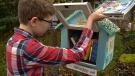 Jack Castell drops books in Little Free Library
