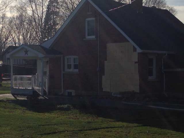 A hole in the side of a home is patched up after a minivan drove into it in Allenford, Ont. on Tuesday, Nov. 17, 2015. (Scott Miller / CTV London)