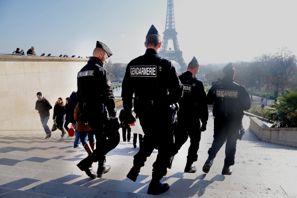 French officers patrol near Eiffel Tower