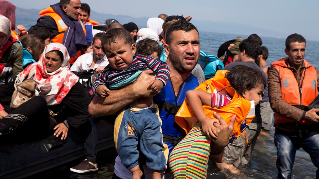 Syrian refugees arrive aboard a dinghy
