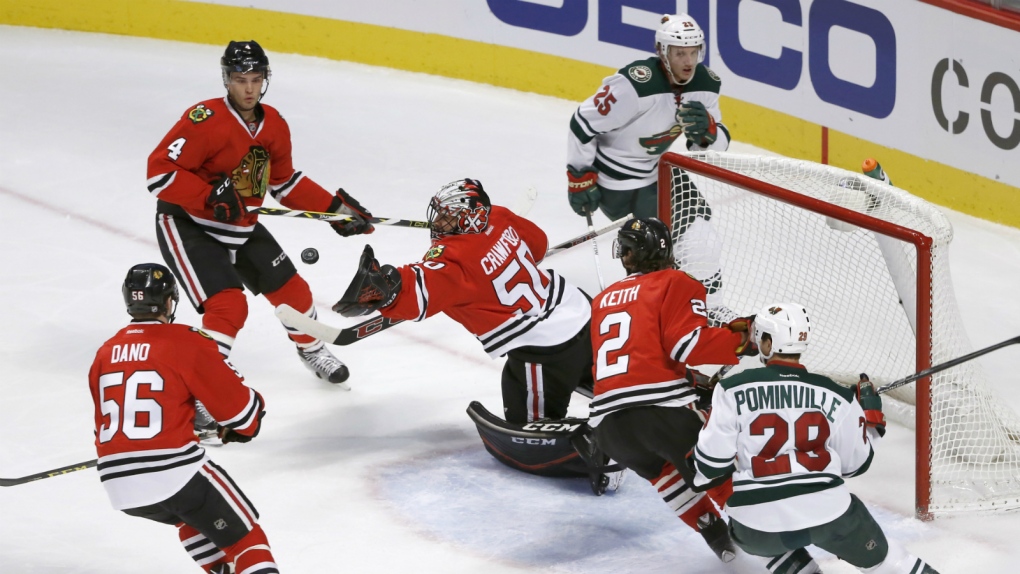 Corey Crawford stretches to make a save