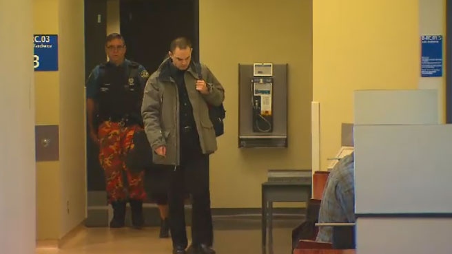 Guy Turcotte walks through a courthouse in 2015