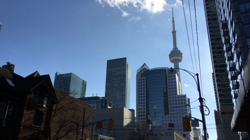 A cloud floats across the CN Tower in downtown Toronto on an unseasonably warm day Friday, December 11, 2015. (Joshua Freeman /CP24)