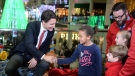 Prime Minister Justin Trudeau is seen greeting children while visiting CTV's Toy Mountain drive at the Toronto Eaton Centre on Dec. 14, 2015. 