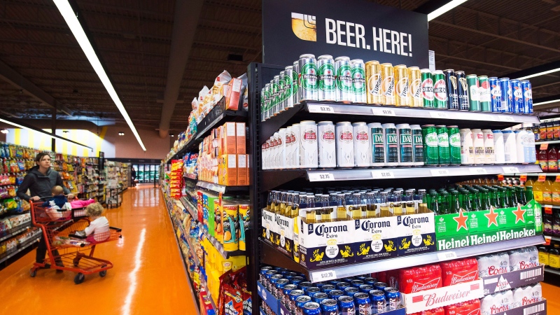 Beer is shown on newly stocked shelves as customers shop at a Loblaws grocery store in Toronto on Tuesday, Dec. 15, 2015. (Nathan Denette / THE CANADIAN PRESS)