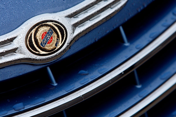 The badge on a Chrysler car covered with rain drops is seen at a showroom in London, Friday, Dec. 12, 2008. (AP / Kirsty Wigglesworth)