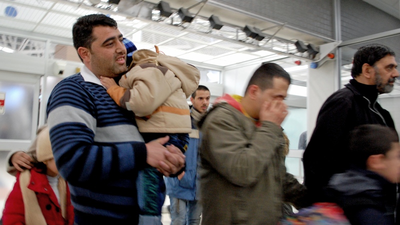 Syrian refugees arrive at the Saskatoon airport late Saturday, Dec. 19, 2015. 