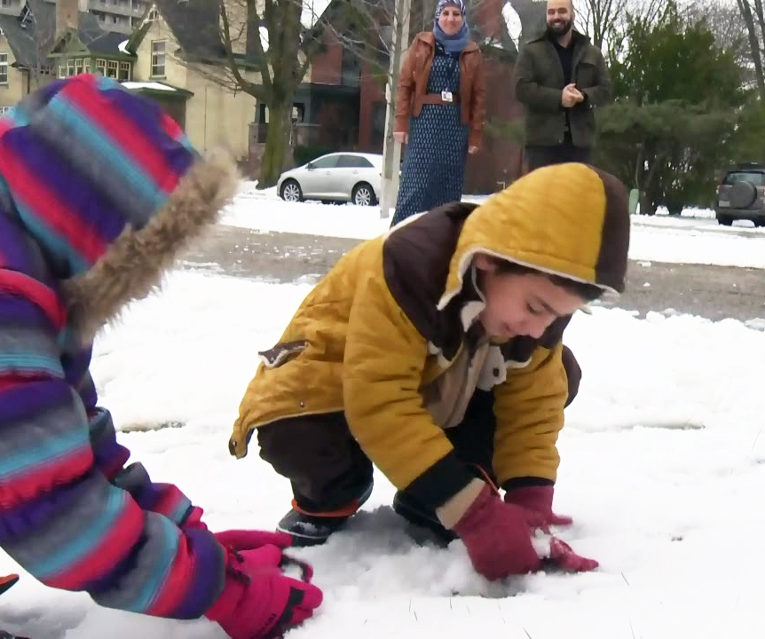 Refugees play in snow