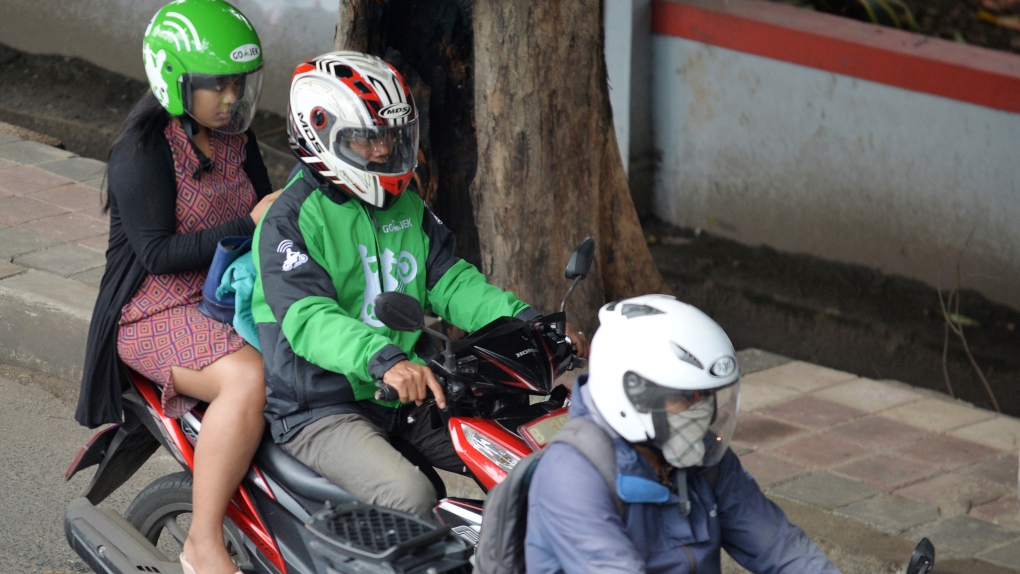 Indonesia's Muslim women hail female-only motorbike taxis | CTV News
