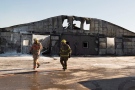 Firefighters walk past a barn that was destroyed by a fire at the Classy Lanes Stables in Puslinch, Ont., on Tuesday, Jan. 5, 2016. More than 40 racehorses were killed when a fire tore through a barn the night before. (THE CANADIAN PRESS / Hannah Yoon)