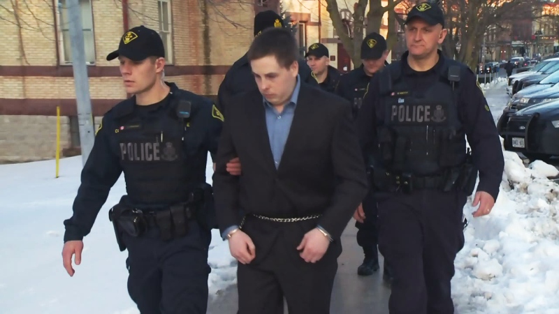 Flanked by police officers, Michael Schweitzer leaves the Stratford courthouse on Thursday, Jan. 7, 2016.