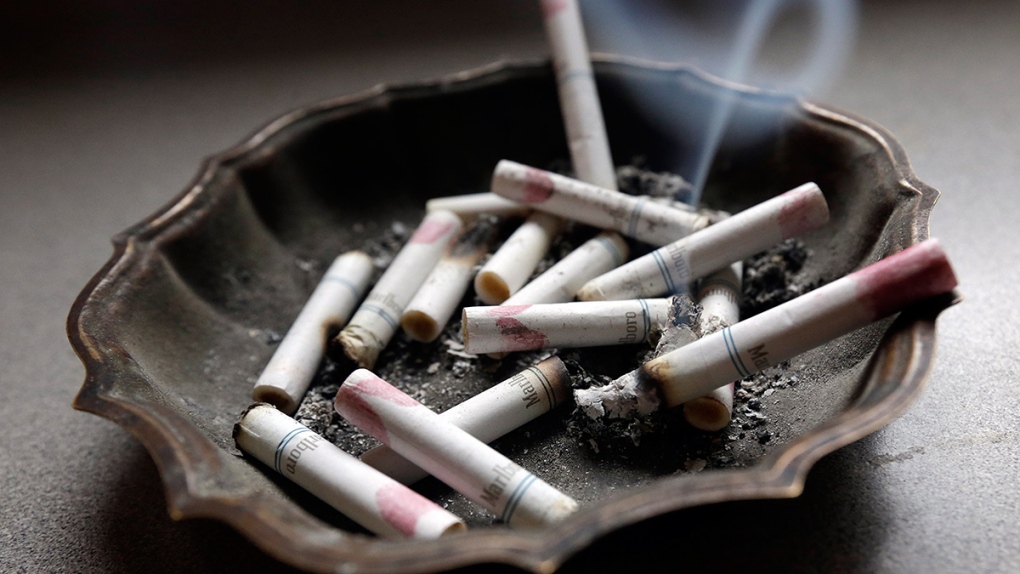 A cigarette burns in an ashtray