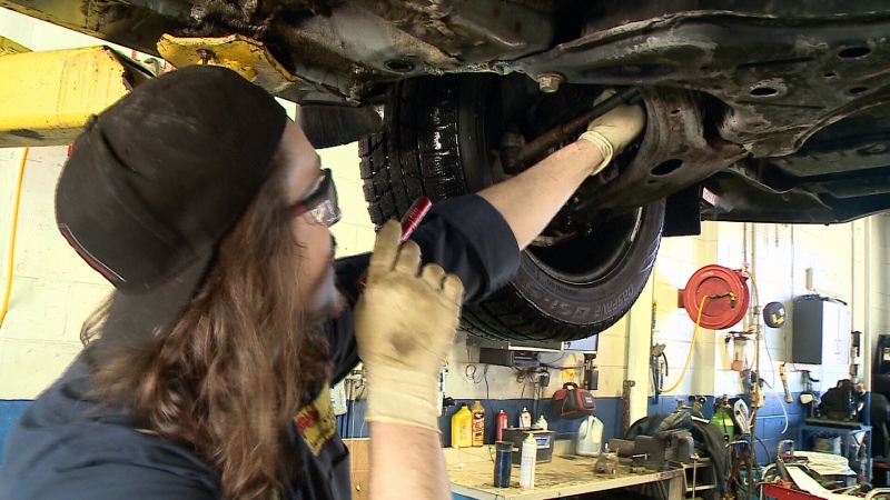 Mechanic Nate Lalonde checks shock absorbers.