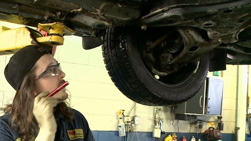 A mechanic inspecting a car