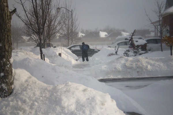 A man shovels his driveway in Caledon, Ont., on Sunday, Dec. 21, 2008, after a snowstorm hit overnight. (Sumran Bhan / CTV.ca)