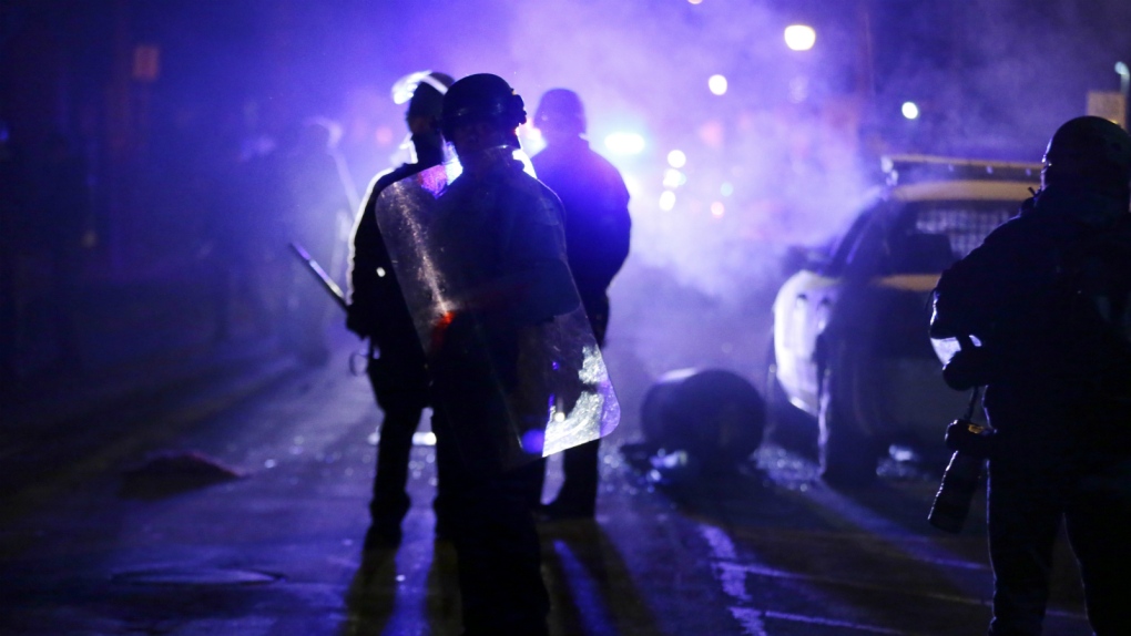Police watch protesters in Ferguson