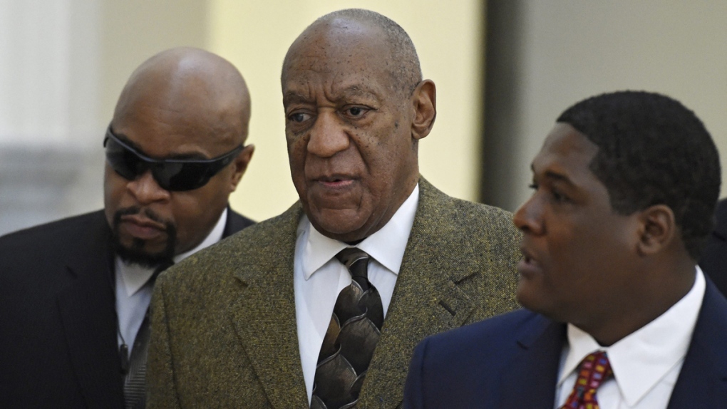 Bill Cosby, centre, arrives for a court appearance