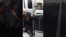 Ehab Taha recently captured this photo of an elderly woman holding the hand of a man who was sitting on the floor of Vancouver's Sky Train. (Ehab Taha / Facebook)